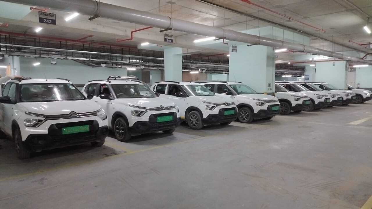 Corporate electric car fleet for employee shuttle services promoting eco-friendly and sustainable commuting.